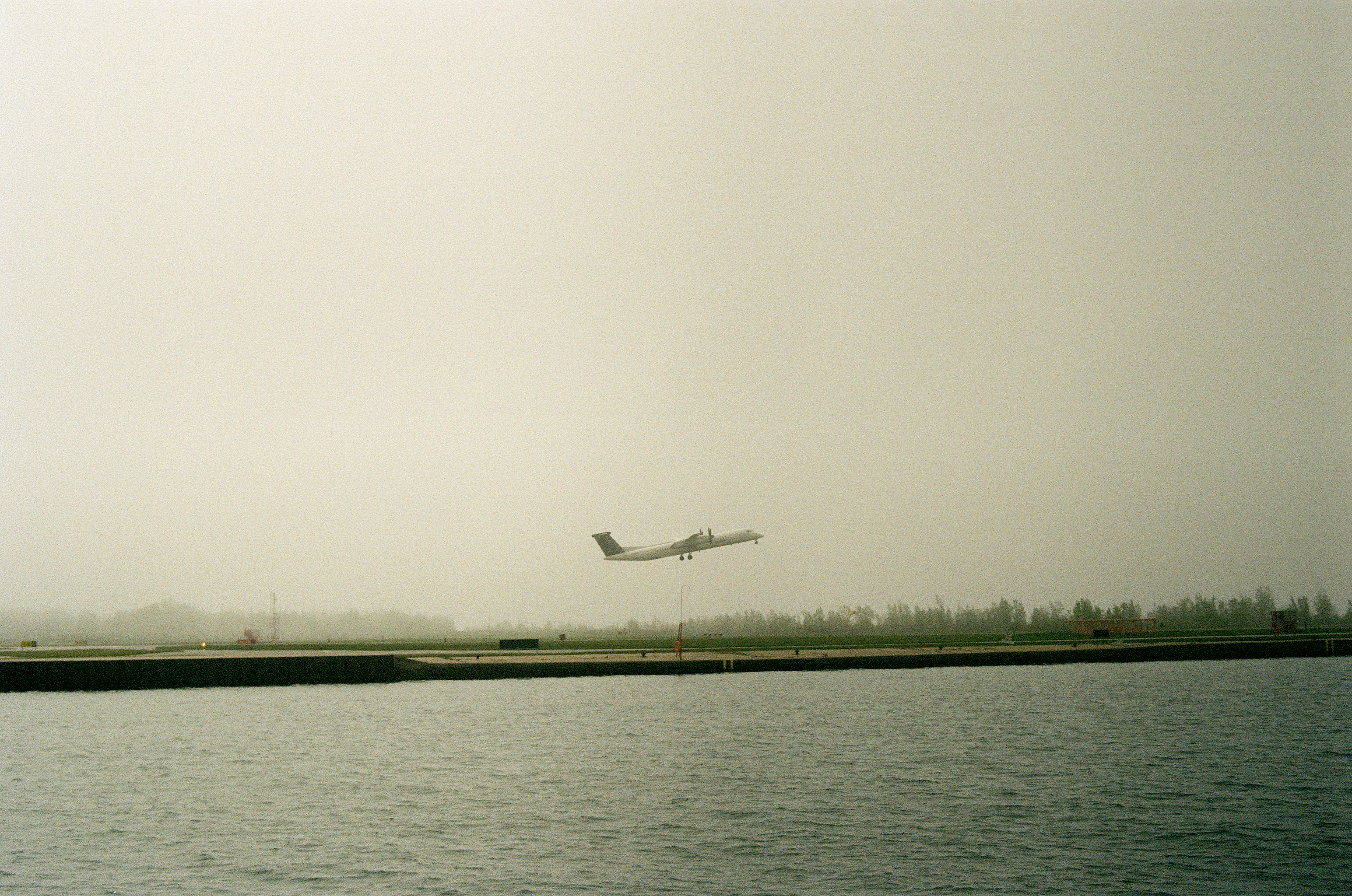 A Porter aircraft taking off into the fog