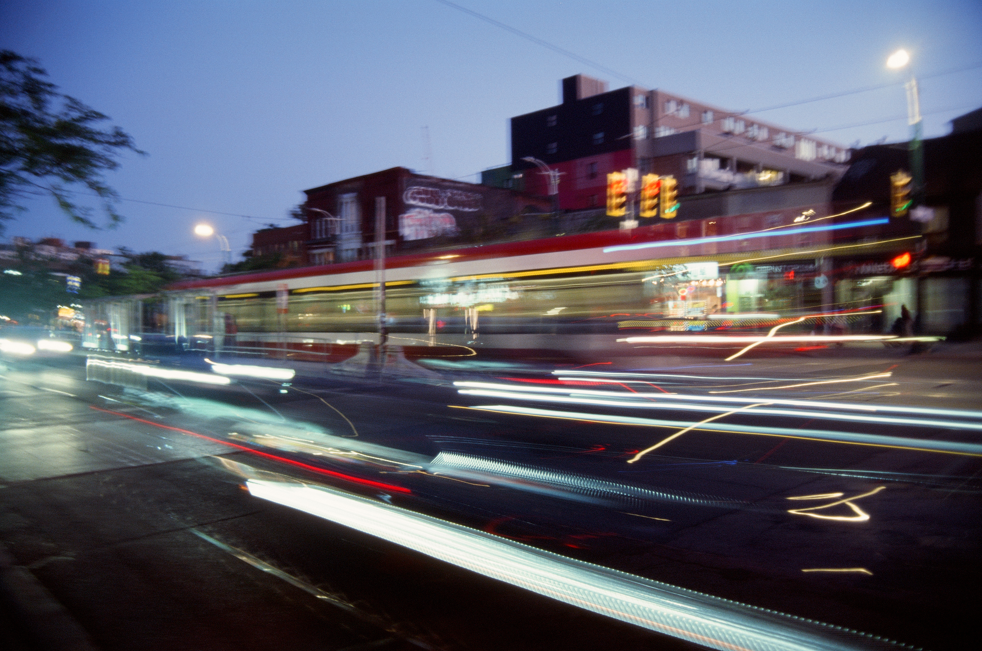 Streaks of lights from a streetcar passing by at dusk